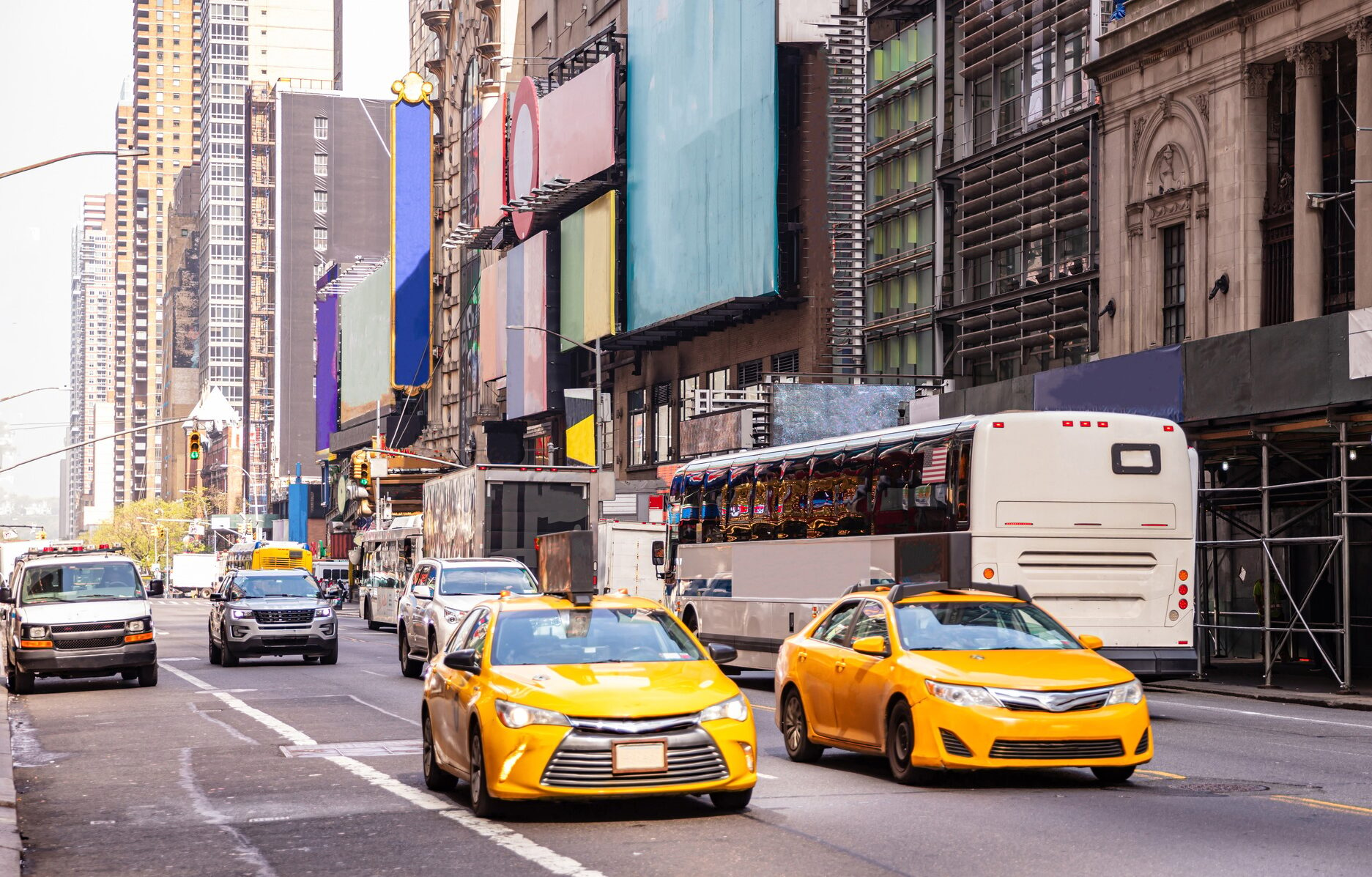 New York, streets. High buildings, colorful signs, cars and cabs